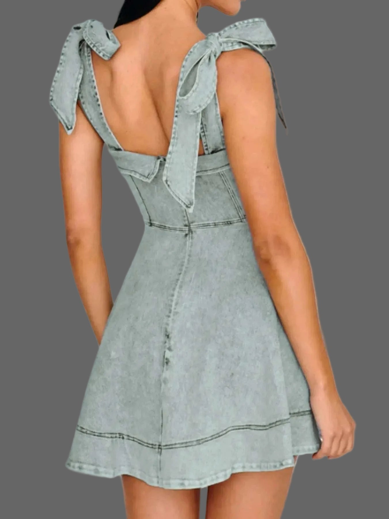 Back view of women’s bow shoulder denim mini dress