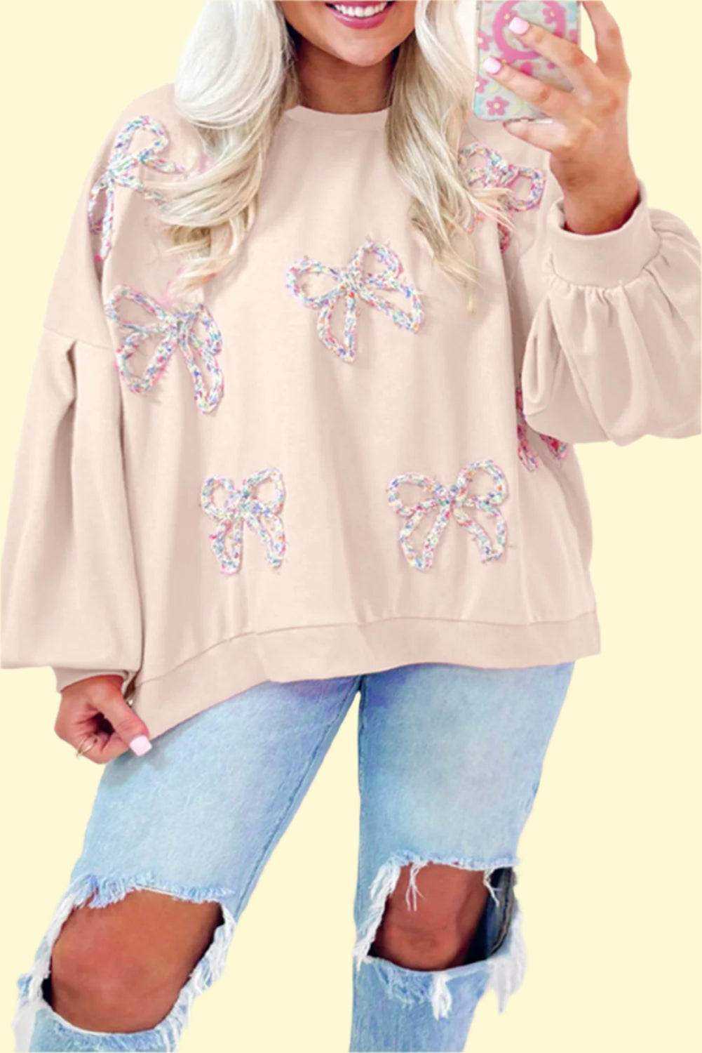 Cream cozy bow accent sweatshirt with long sleeves