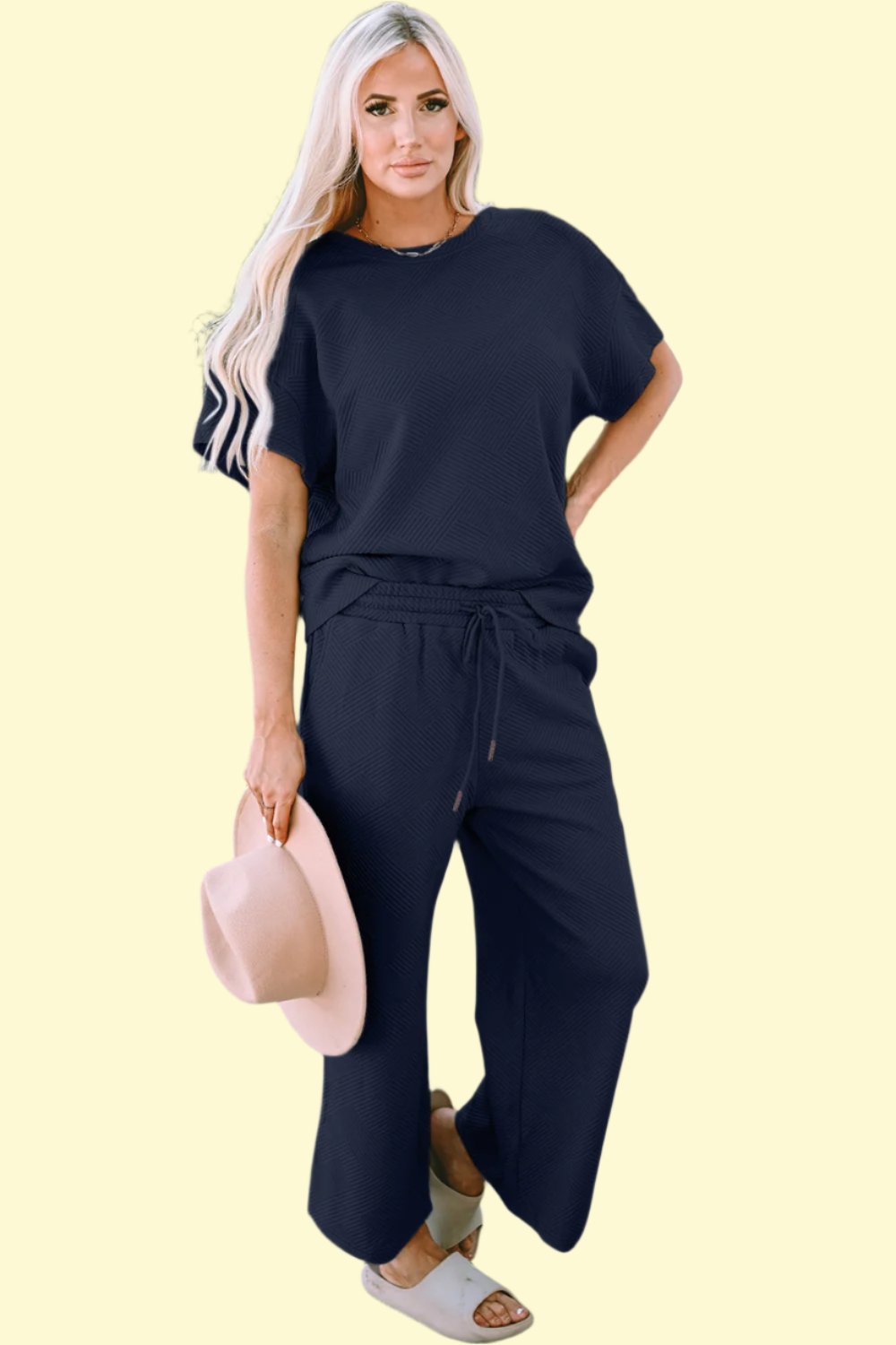 Model lounging comfortably in the navy set