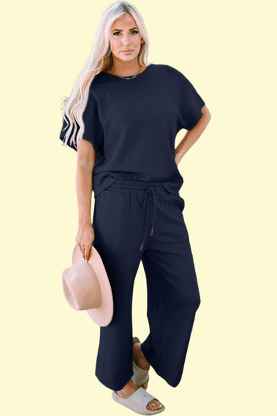 Model lounging comfortably in the navy set