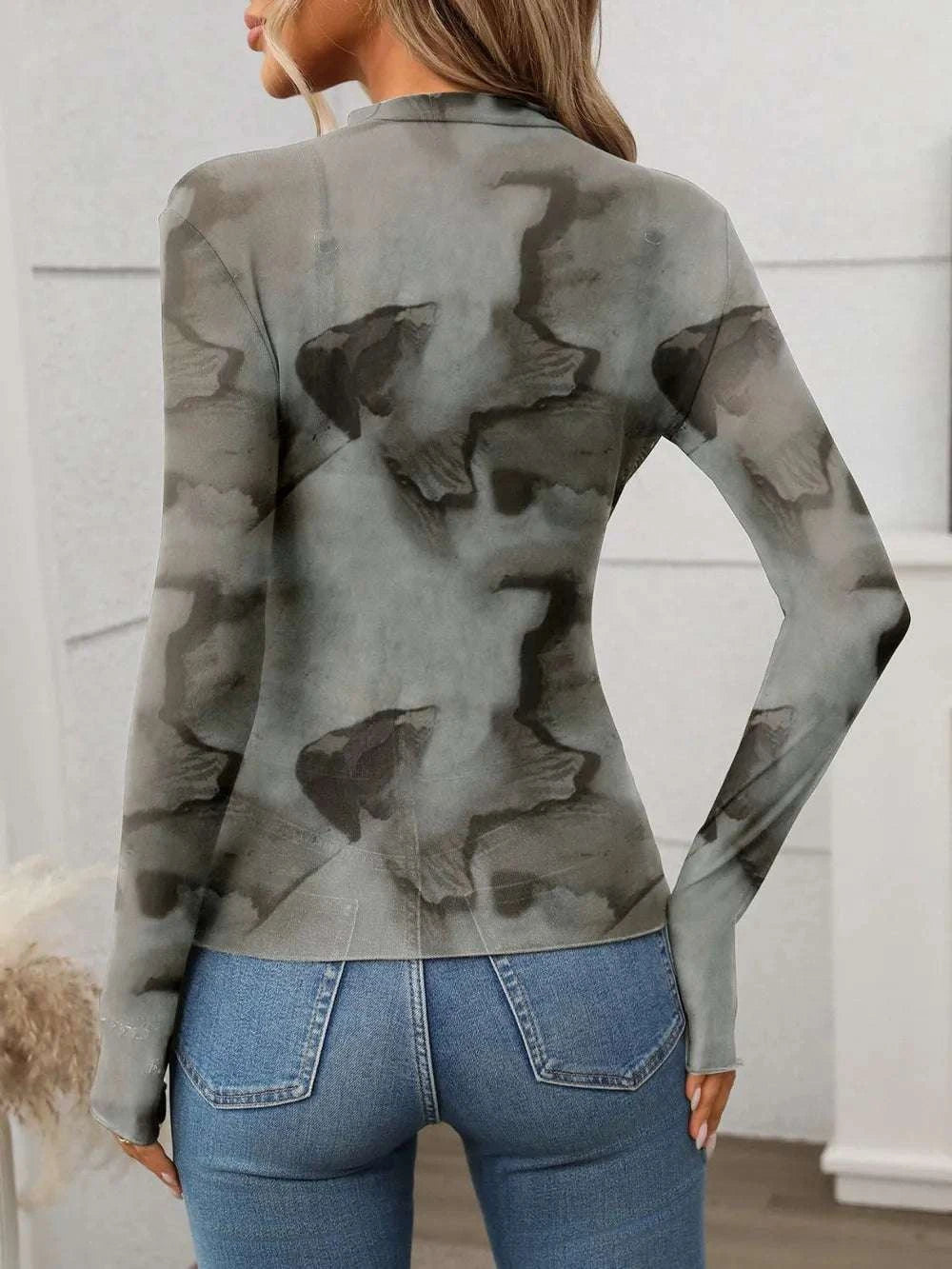 Back view of mock neck printed mesh top for women