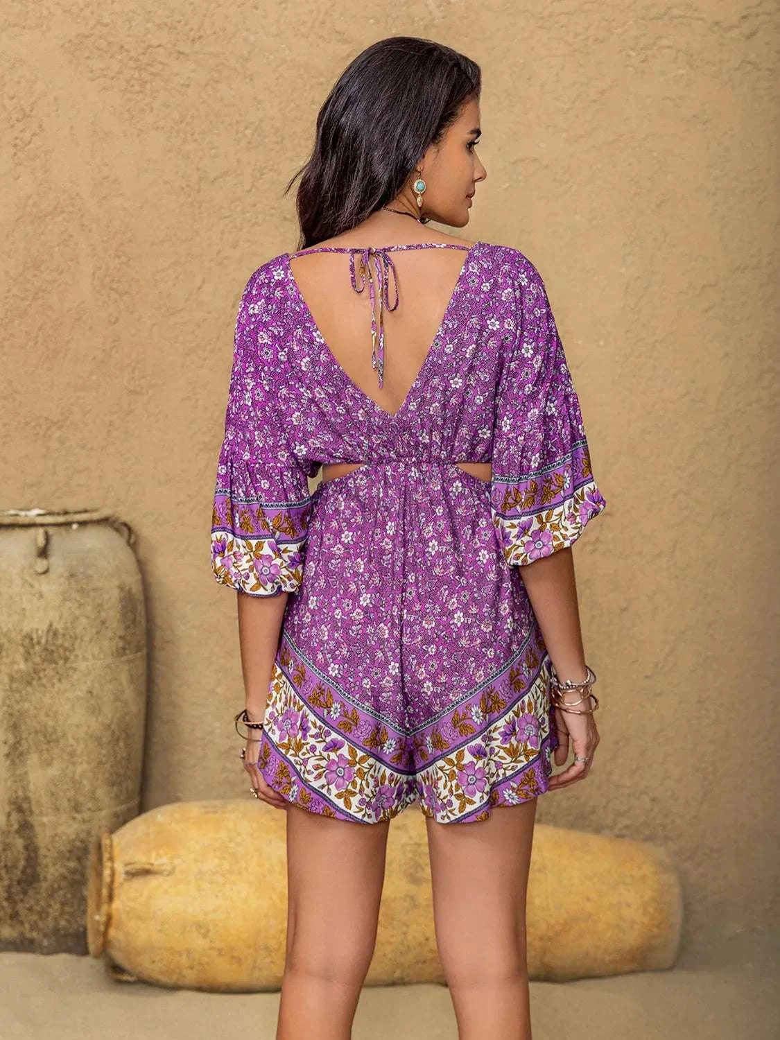 Back view of purple printed cutout romper for women