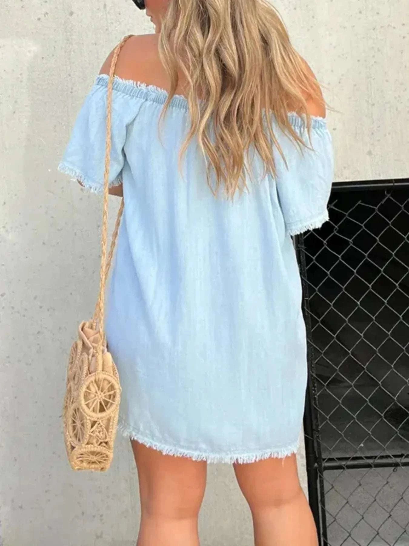 Back view of raw hem denim mini dress