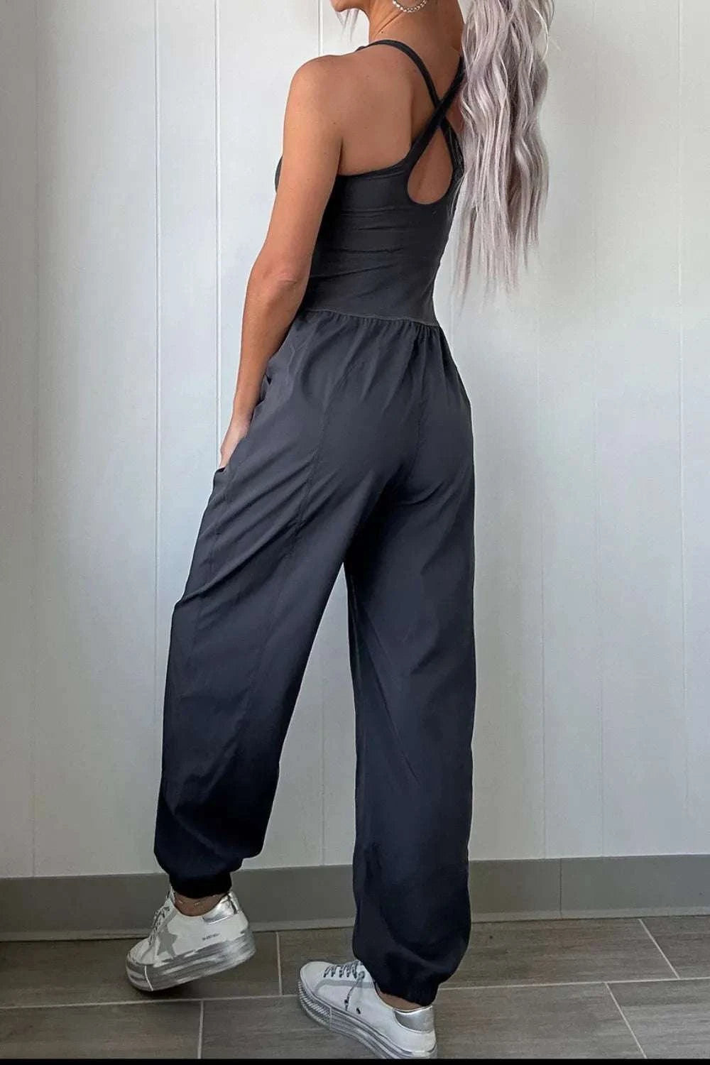Back view of women cutout crisscross active jumpsuit