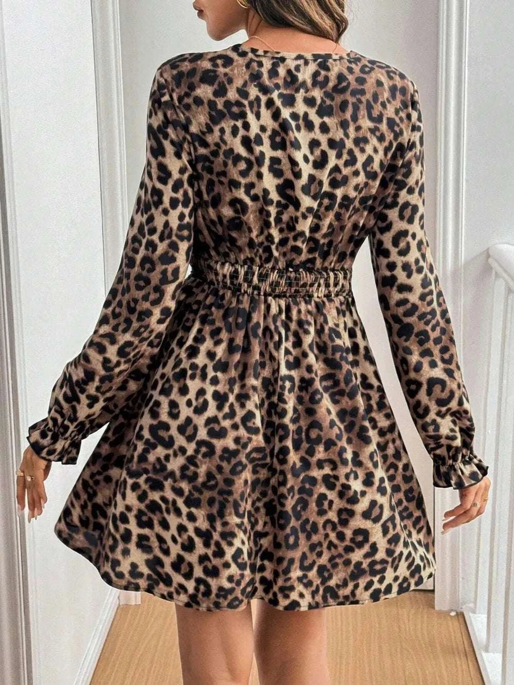 Back view of women’s leopard mini dress