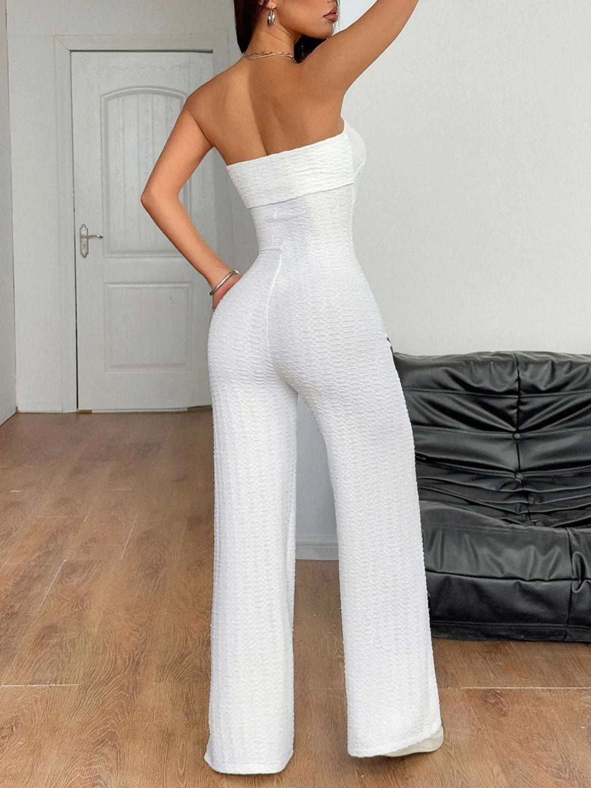Back view of women’s strapless white jumpsuit