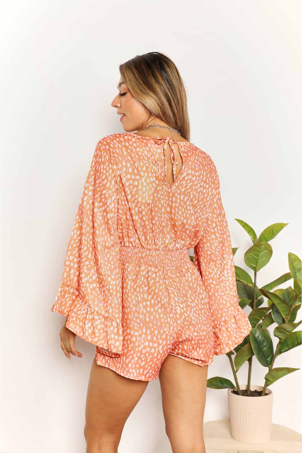 Back view of women’s surplice neckline printed romper