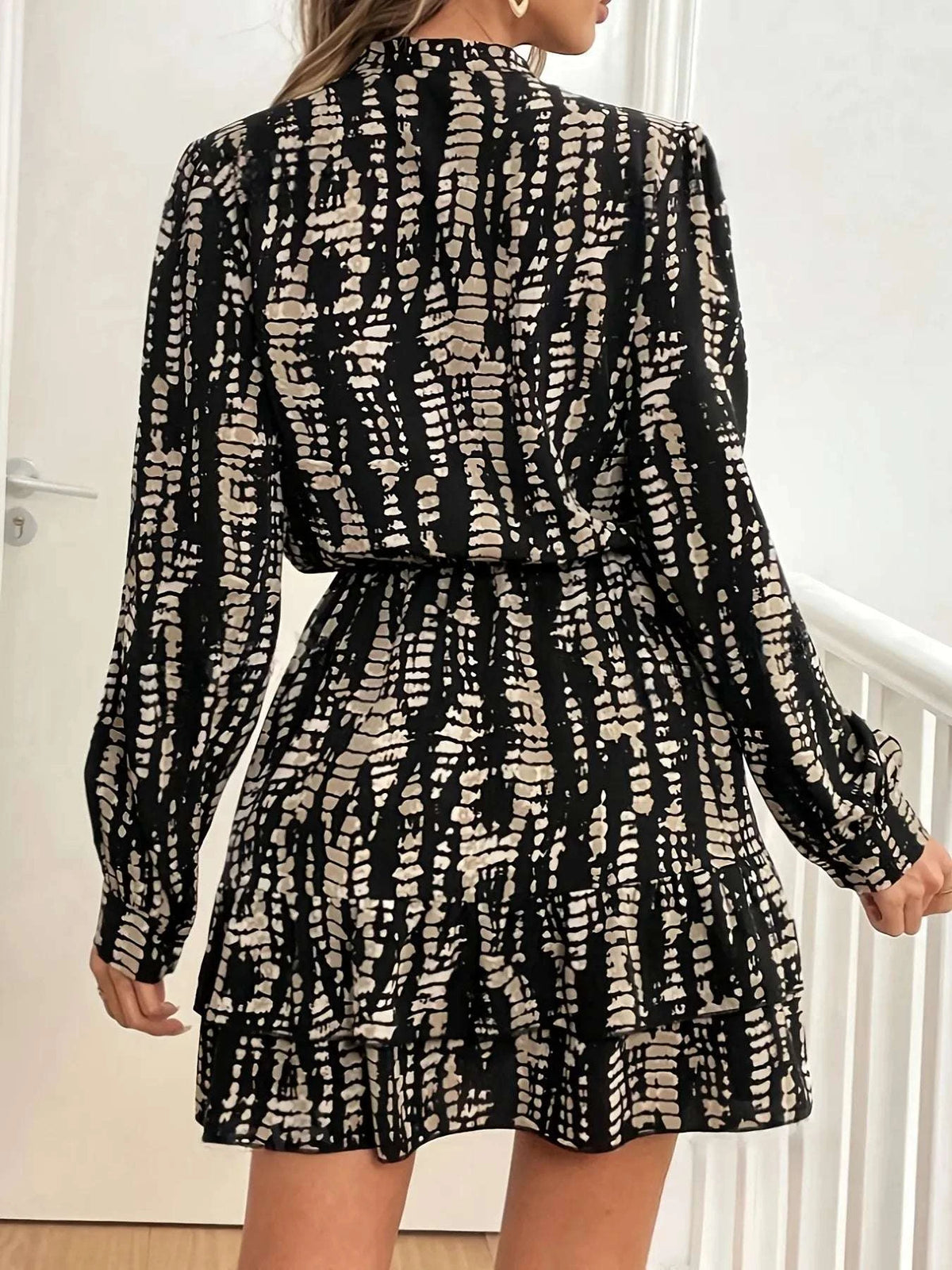 Back view of women wearing black tie-dye long sleeve mini dress