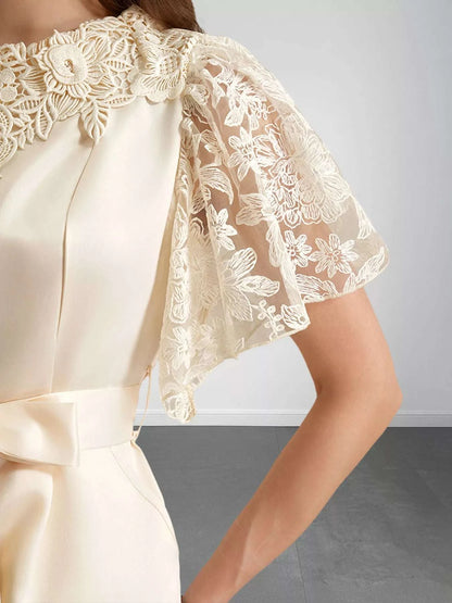 Close-up lace trim detail on women’s apricot jumpsuit