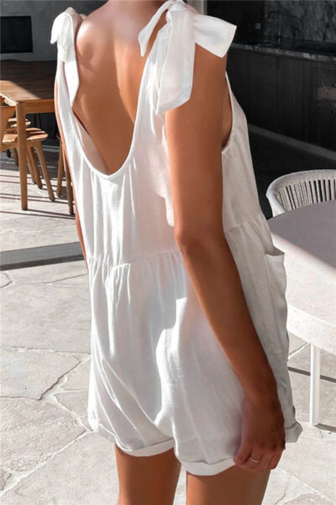 Close-up of bow detail on women’s tie shoulder romper