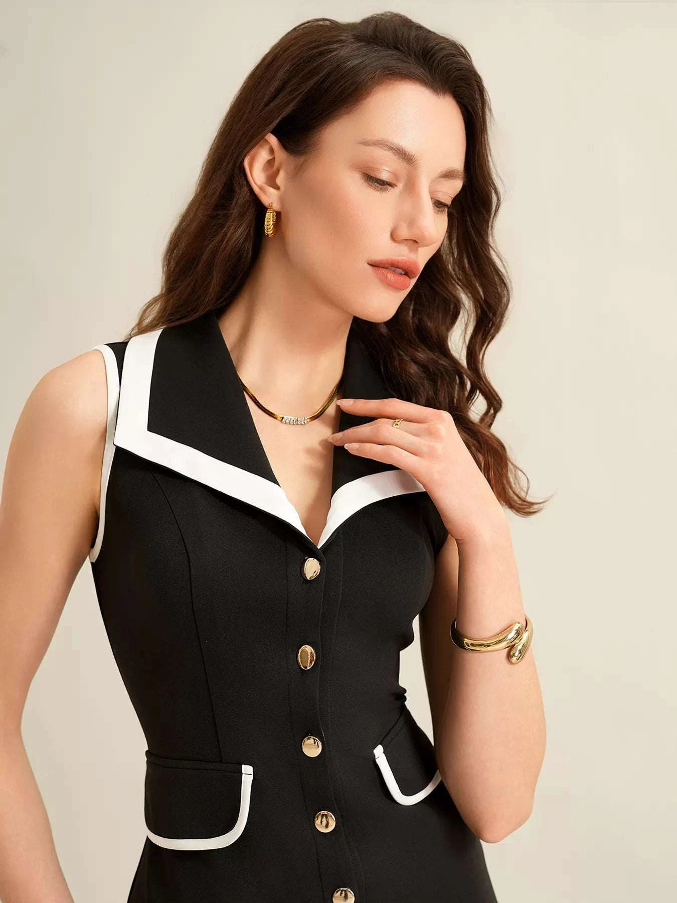 Close-up of button detailing on women’s black dress