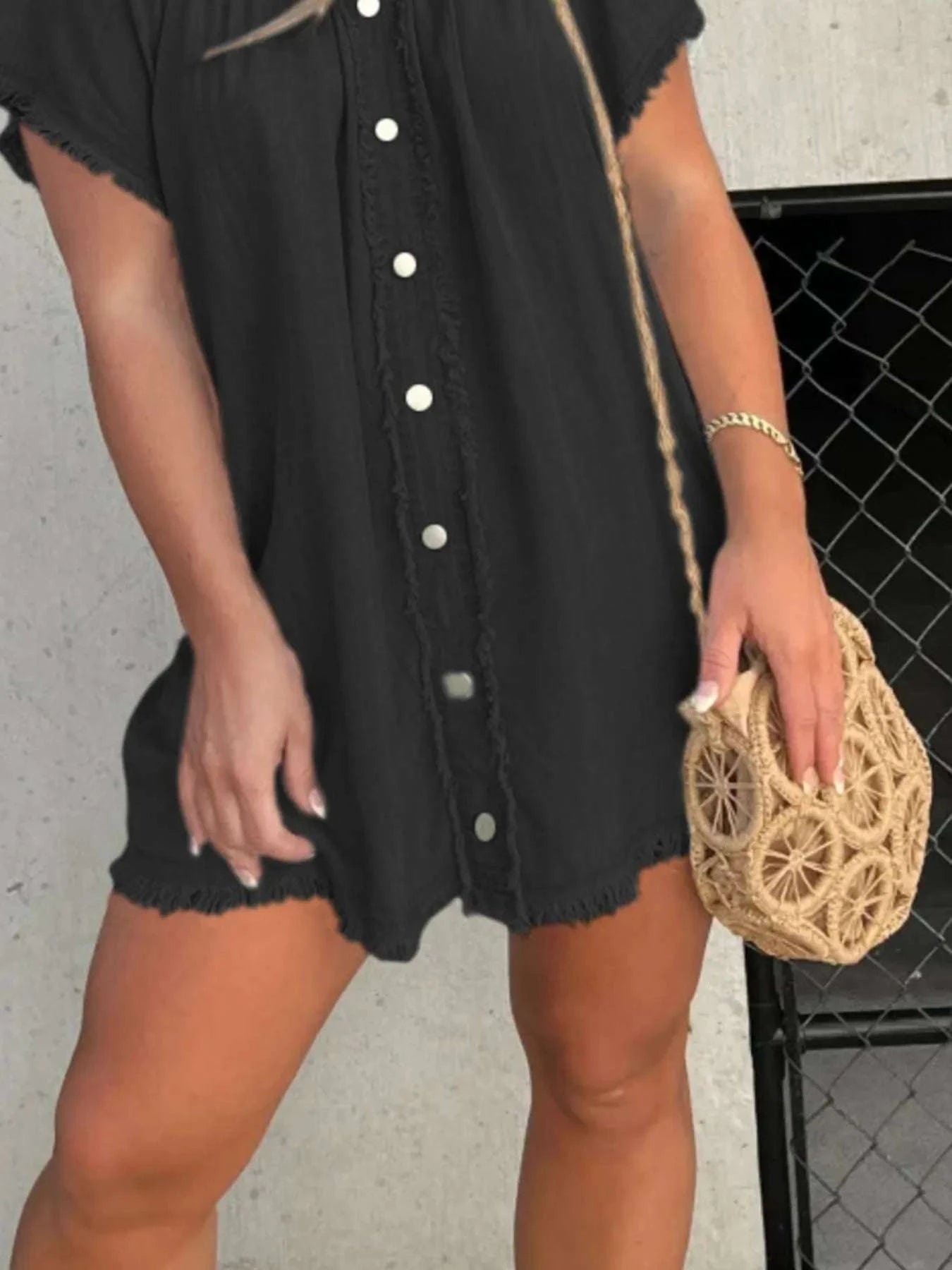 Close-up of raw hem detail on denim mini dress