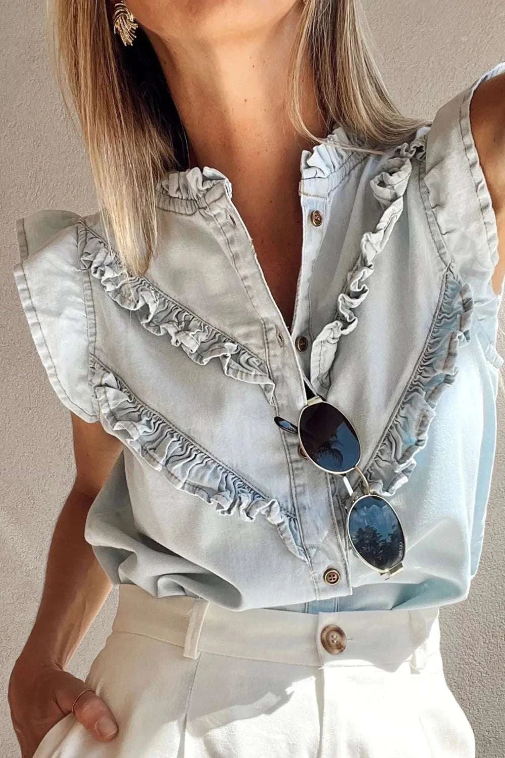 Close-up of ruffle detailing on women’s denim top