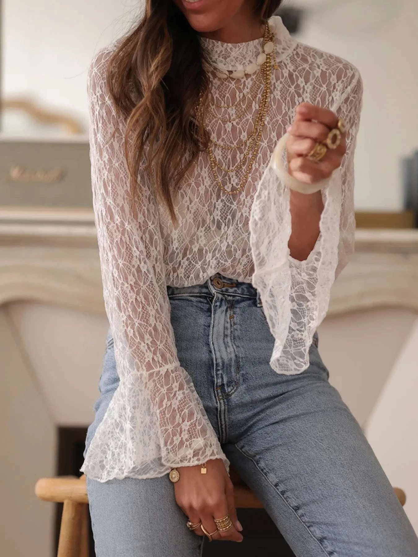 Close-up of sheer lace fabric on women’s blouse
