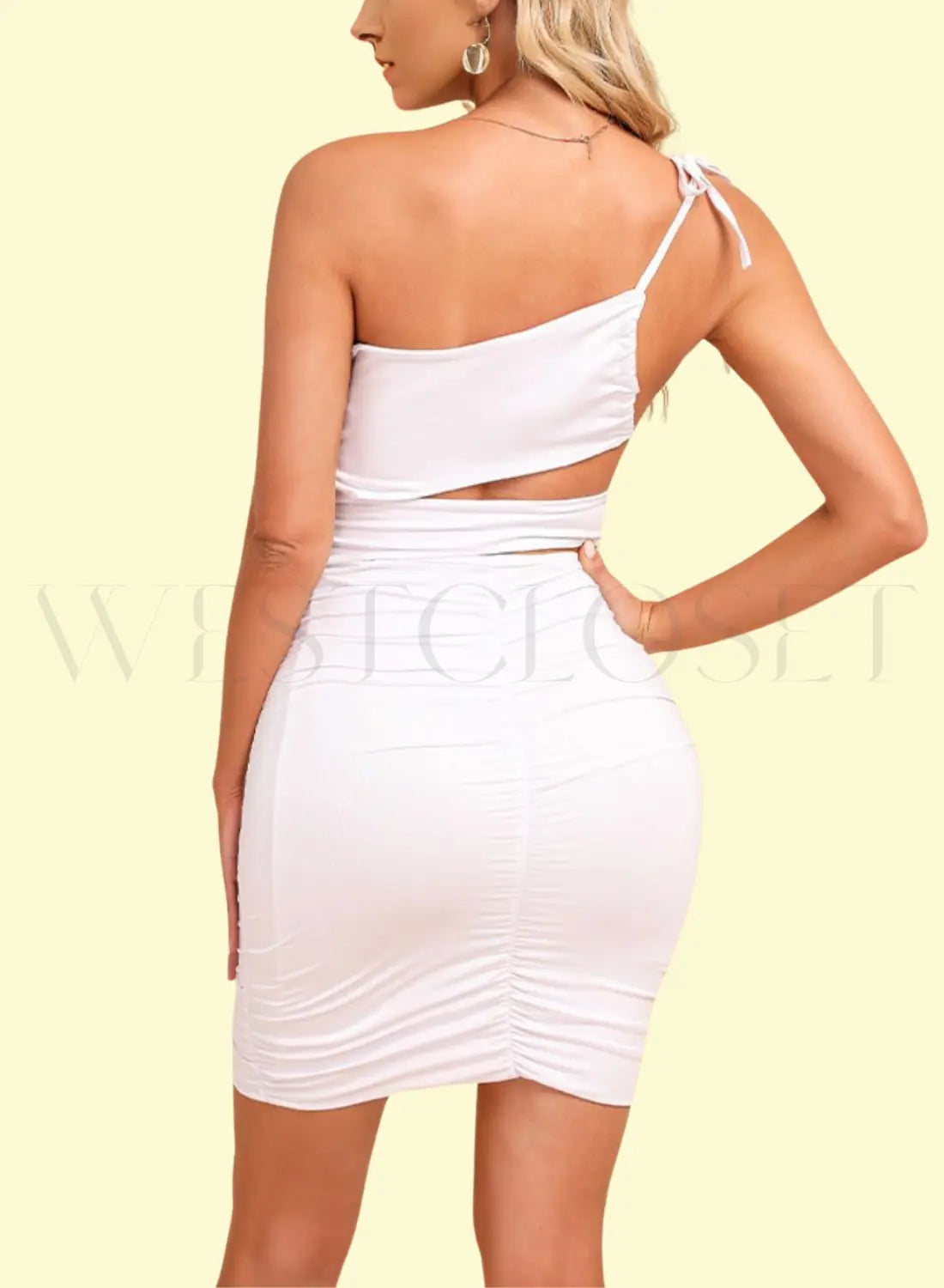 Model striking a pose in a sultry one-shoulder bodycon dress