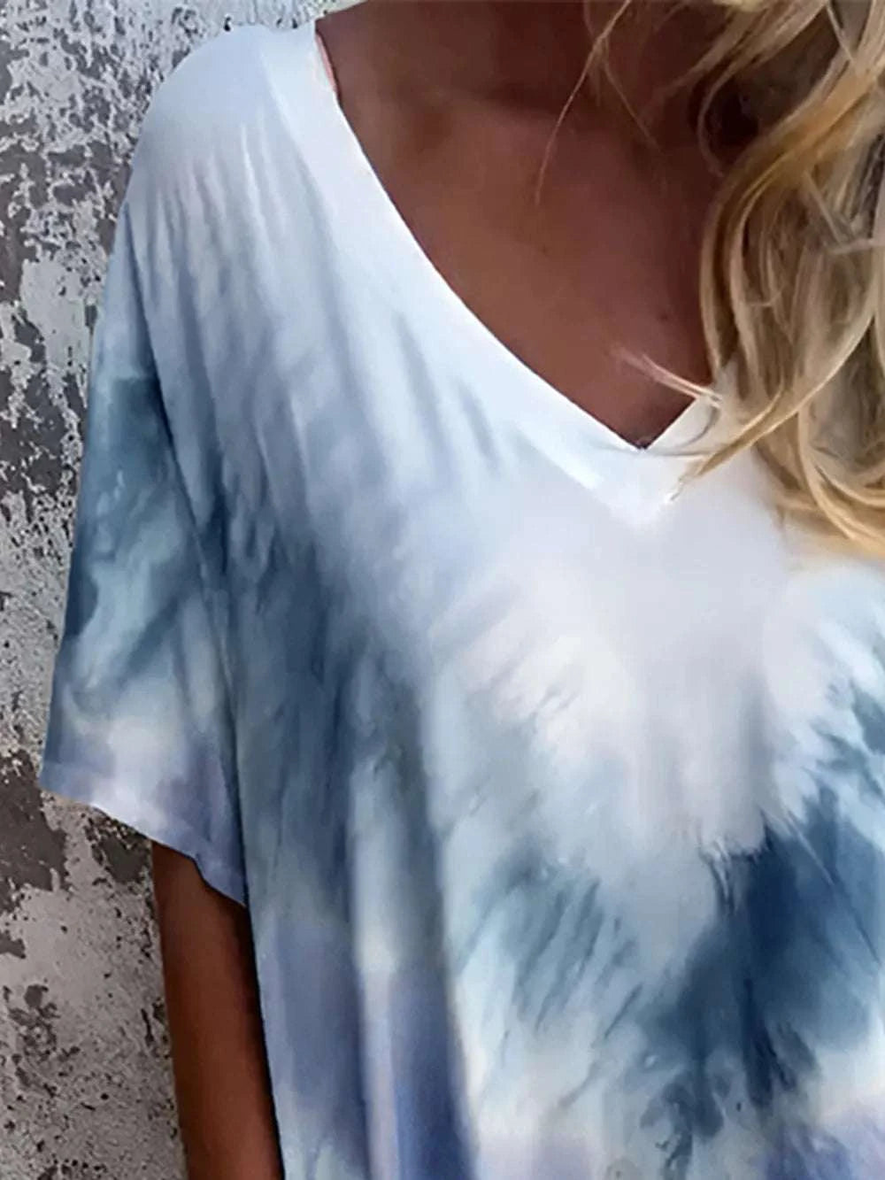 Person wearing a tie-dye shirt with blue and white patterns