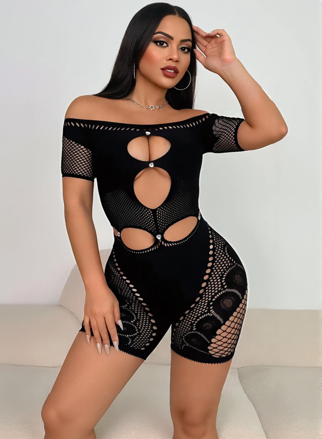 Women’s black fishing net romper with off-shoulder design