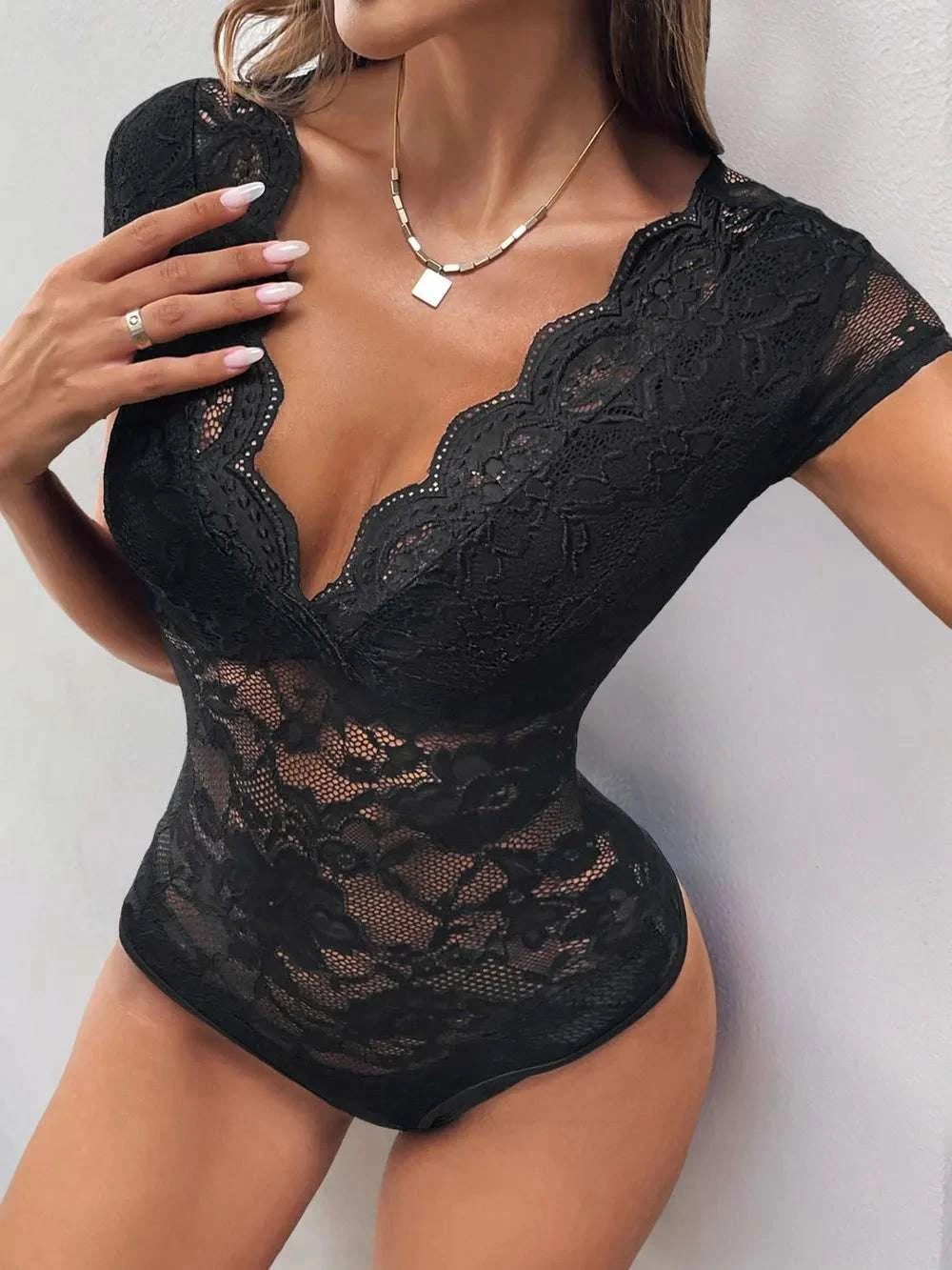 Women wearing black lace bodysuit with V-neck design
